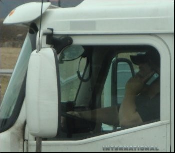 Truck Driver on Cell Phone in 18-Wheeler